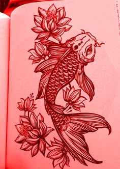 an open book with a drawing of a koi fish and flowers on the cover