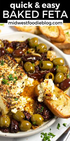 a white plate topped with bread and olives