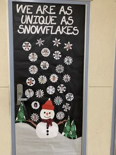 a door decorated with snowflakes and a sign that says we are as unique as snowflakes