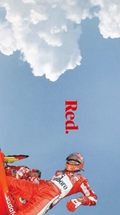 a man flying through the air on top of a snowboard in front of a cloudy blue sky