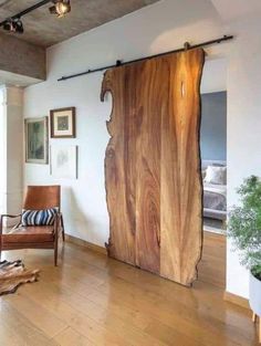 a living room with wood flooring and a sliding door in the middle of it