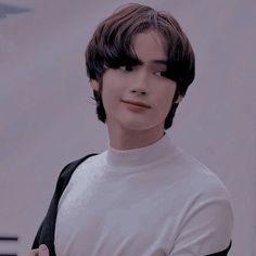 a male mannequin is wearing a white shirt and black backpack with his hands on his chest