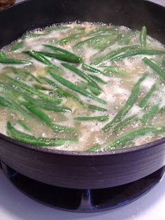 green beans are being cooked in a pan on the stove