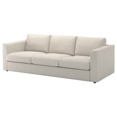 a white couch sitting on top of a white floor