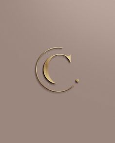 the letter c is made up of gold foil and has a crescent shape on it