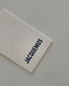 a piece of paper with the word jacquemus on it sitting on top of a table