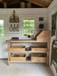 the inside of a small house with shelves and drawers on each side of the door