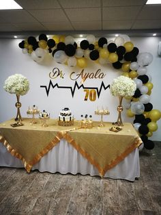 a table topped with cake and dessert covered in balloons