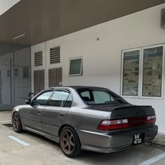 a silver car parked in front of a building