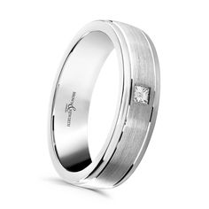 a white gold wedding ring with a princess cut diamond in the center and channeled sides