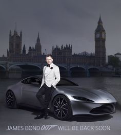 a man in a tuxedo standing next to a silver sports car with big ben in the background