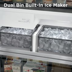 an ice maker with two bins full of ice in it's display case