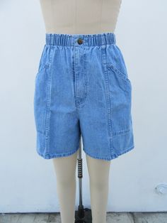 90s high waist denim shorts.  Light wash. All cotton. Elastic waist. Side pockets. Made in Mexico for CHEROKEE.  Label size Small Please compare measurements to a similar garment that fits you well Measured flat 25 to 30" elastic waist 40" hips 13-3/4" rise 6" inseam  Good + vintage condition with minimal signs of use and age. Retro High Rise Denim Shorts, Medium Wash High-waisted Shorts With Elastic Waistband, High-waisted Elastic Waistband Medium Wash Shorts, Retro High Waist Medium Wash Shorts, Retro High Waist Denim Shorts, Retro High-waist Medium Wash Shorts, Retro High-waist Denim Shorts, Retro High Waist Medium Wash Jean Shorts, Retro High Waist Denim Blue Shorts