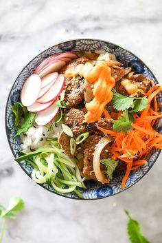 a bowl filled with meat and vegetables on top of a table