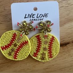 the beaded earrings are yellow and red, with beads on each earring that says live love gameday