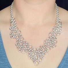 This asymmetrical yet excellently balanced necklace is an absolute show stopper. The organic pattern of sterling silver links looks almost like something grown rather than assembled by hand; a one-of-a kind piece that is sure to turn heads. At 19.5 inches long this necklace is perfect to wear with a low neckline, or over a turtleneck. This style of chainmail jewelry is also wonderfully modular, so please contact me if you would like a different length! One week is typical, but please allow three Chainmaille Patterns, Handmade Chain Jewelry, Chainmaille Jewelry Patterns, Chainmail Patterns, Chain Art, Jump Ring Jewelry, Chainmail Necklace, Chainmaille Jewelry, Chainmail Jewelry