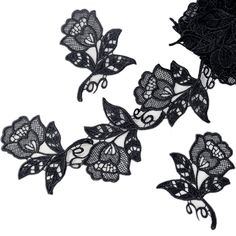 three pieces of black lace with flowers on them