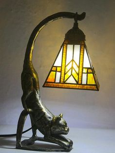 a lamp that has a cat on it and is next to a light fixture in the shape of a cat