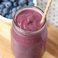 a blueberry smoothie in a mason jar with a straw