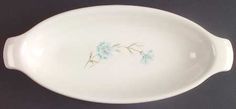 a white bowl with blue flowers painted on the bottom and sides, sitting on a black surface