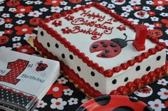 a ladybug themed birthday cake on a table