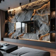 a living room with large rocks on the wall and television in the corner, as well as a couch