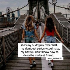 two girls walking across a bridge holding hands with the caption she's my buddy, my other half