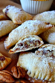 several pastries on a plate with pecans around them