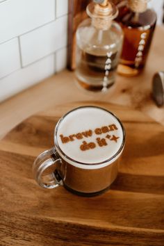 a cappuccino with the word happy on it sits on a wooden table