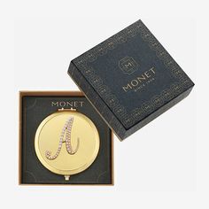 a gold plated monogrammed necklace in a gift box