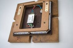 an electronic device is attached to a piece of wood