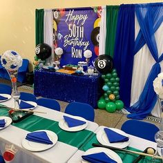 a table set up for a birthday party with balloons and streamers