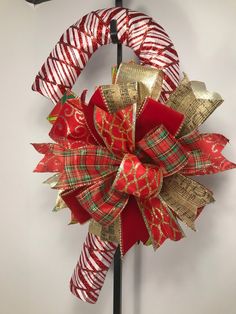 a red and gold christmas wreath hanging on a wall