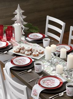 the table is set for christmas dinner with red and white plates