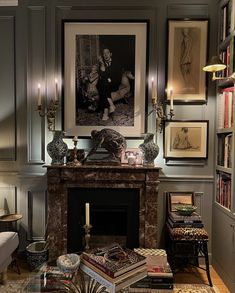 a living room filled with furniture and a fire place covered in pictures on the wall