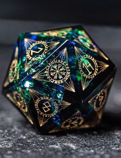 a black and gold dice sitting on top of a table