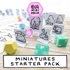 miniature dices are sitting next to each other on a table with the words minitures starter pack