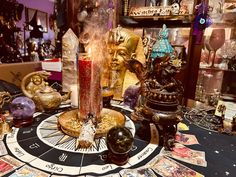 a table topped with lots of different types of candles and other decorative items on top of it