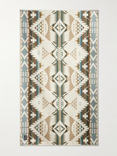 a rug with an abstract design on the front and back of it in beige, blue, green and white colors