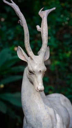 a statue of an antelope with horns on it's head is shown