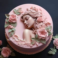 a pink cake decorated with flowers and a woman's face