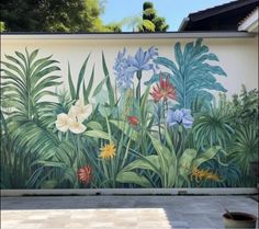 a mural on the side of a building with flowers and plants painted on it's wall