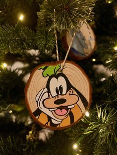 a wooden ornament hanging from a christmas tree