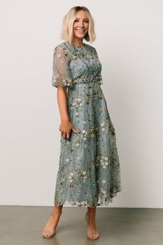 Our Arabella Embroidered Tulle Maxi Dress is magical! This gorgeous light blue dress features gold and ivory floral with stunning tulle material. Floral Print Mother Of The Bride Dresses, Mid Length Mother Of The Bride Dresses, Sage Green Dress Floral, Floral Mob Dress, Floral Mother Of The Bride Dress, Mother Of The Bride Floral Dress, Spring Outdoor Wedding Guest Dress, Mother Of Bride And Groom Dresses, Dusty Blue Wedding Guest Dress