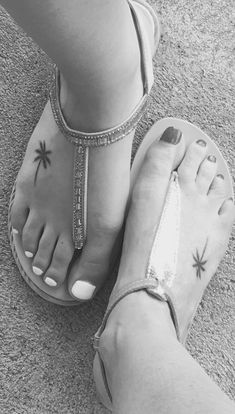 two people wearing sandals with palm trees on them