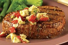 steak with vegetables on the side and broccoli in the backgroung