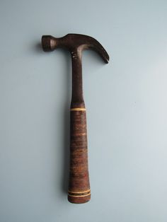 an old hammer is hanging on the wall