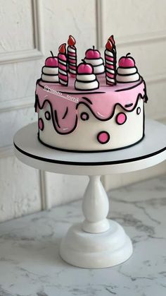 a birthday cake with pink frosting and lit candles on top is sitting on a white pedestal