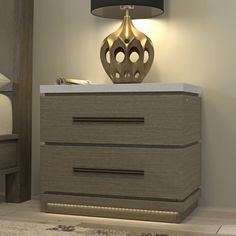 a nightstand with a lamp on top of it next to a night stand and bed