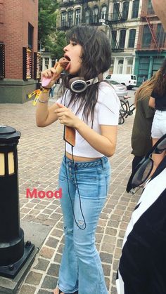 a woman standing next to a street eating food